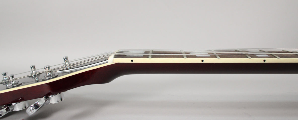 The guitar's dark red neck and headstock are viewed from the side, showing chrome tuners and white binding along the fretboard.
