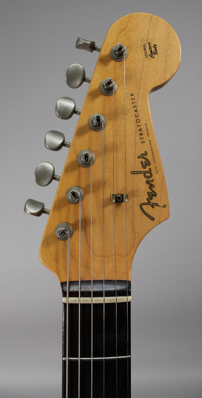Close-up of the guitar's headstock, showing six aged nickel tuners, a string tree, and a dark rosewood fretboard with a bone nut.