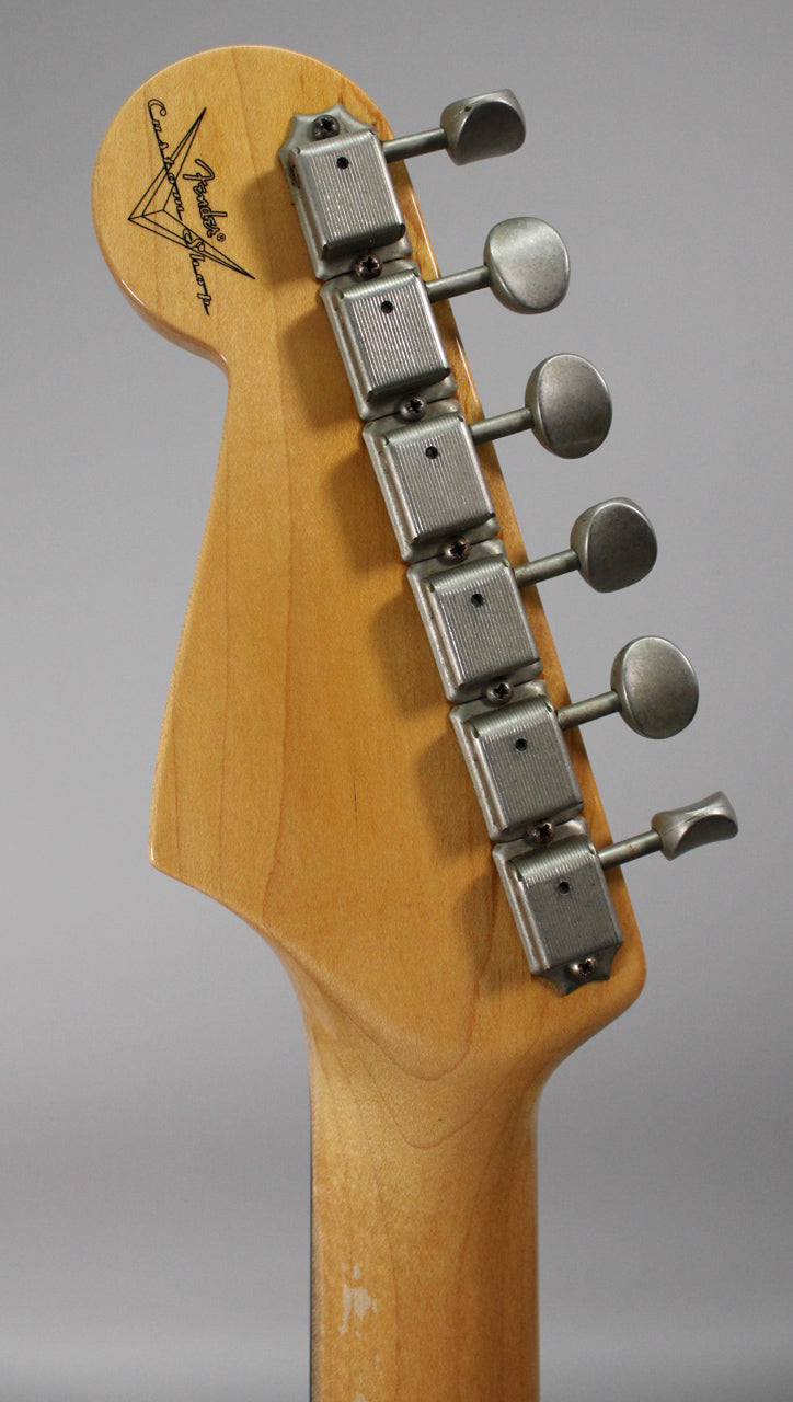 The maple headstock and neck heel are visible from behind, showing six aged nickel tuners and light finish wear.