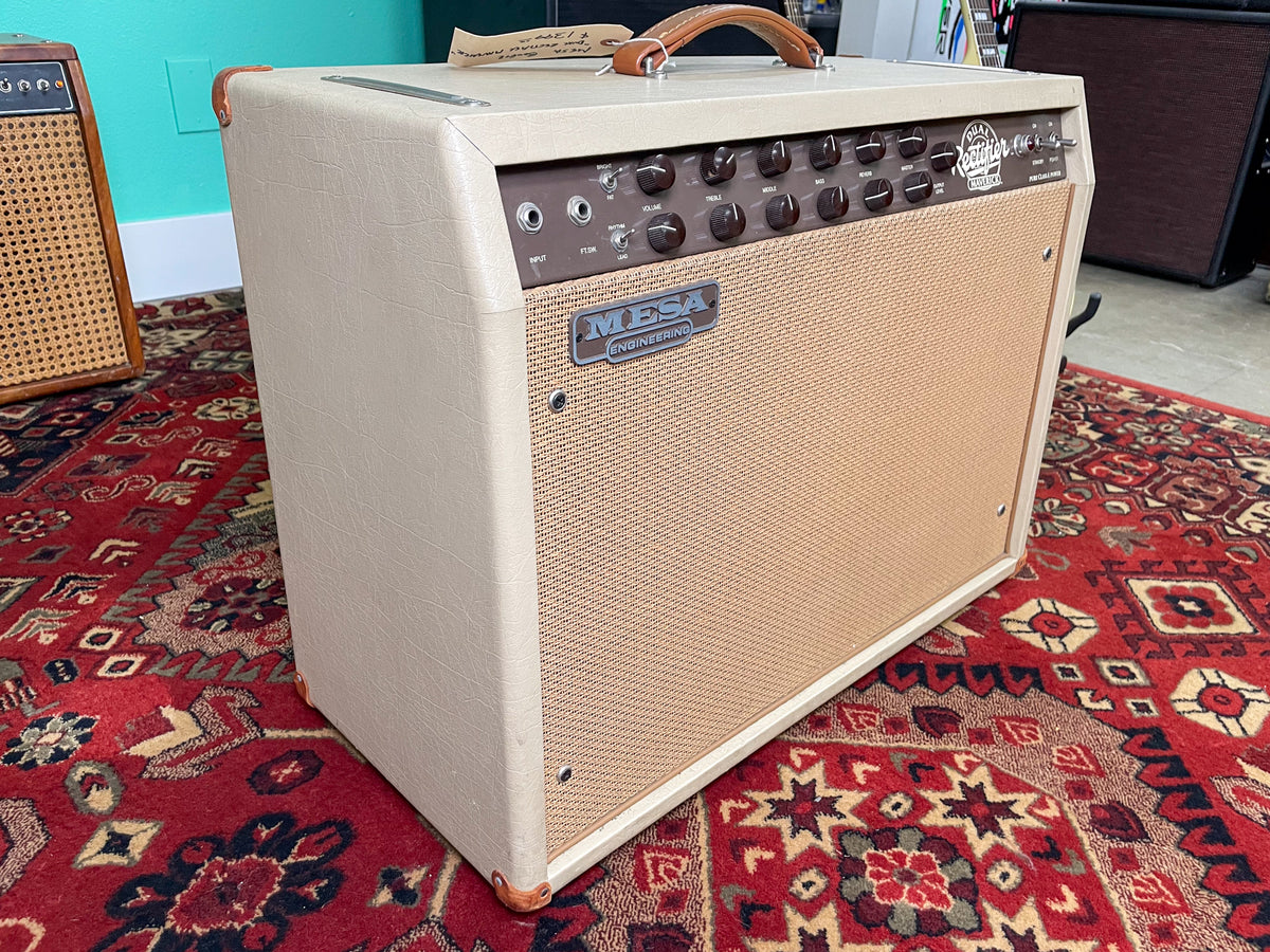 Angled view of a beige combo amp with a tan grille, brown control panel, and a leather handle.