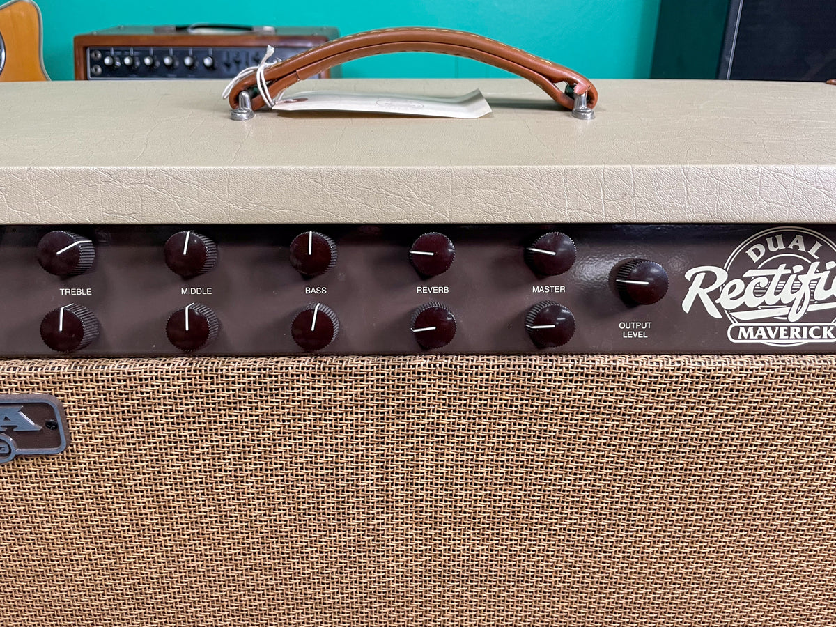 Close-up of the amp's tan tolex top and brown control panel with black knobs, above a tan woven grille.