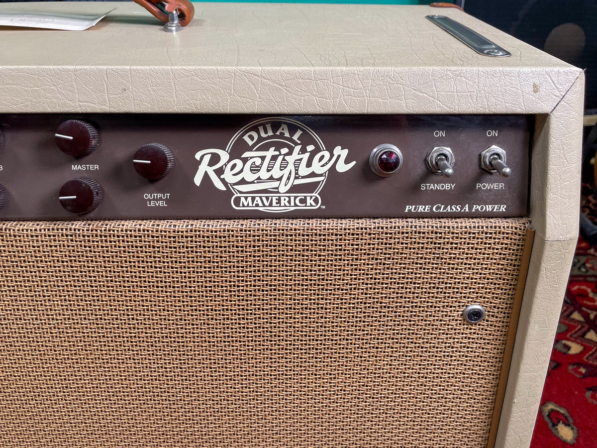 Close-up of the amp's tan textured cabinet and brown control panel with black knobs, red jewel light, and two toggle switches.