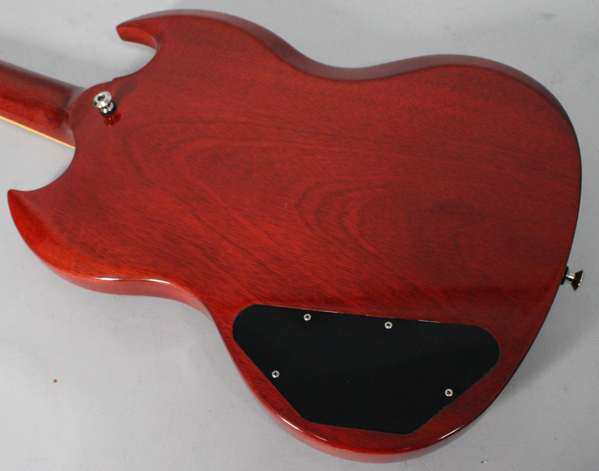 The back of a cherry red SG Standard, showing the neck joint, strap button, and black control cavity cover.