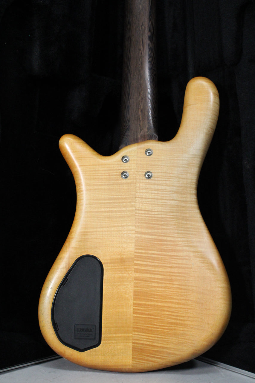The bass's natural transparent satin finish back shows flame maple grain, a black control cavity cover, and four neck bolts.