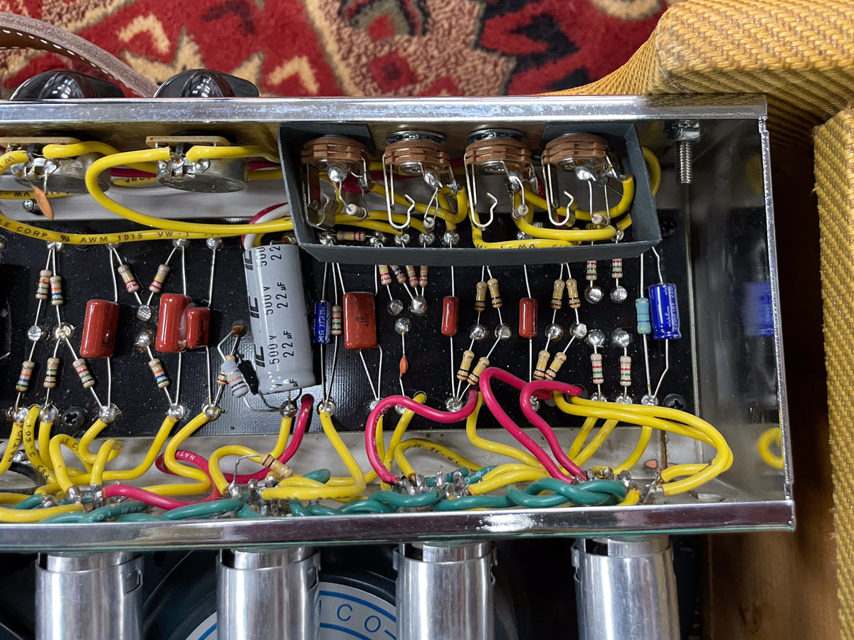 Close-up of the amp's internal wiring, showing colorful wires, resistors, and capacitors on a black circuit board.