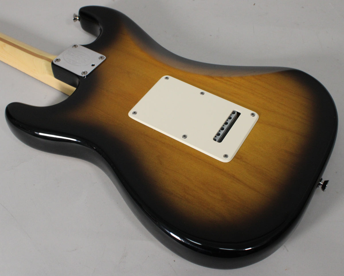 The guitar's back, in 2-color sunburst, shows a cream tremolo cover and a chrome neck plate with a visible 50th Anniversary logo.