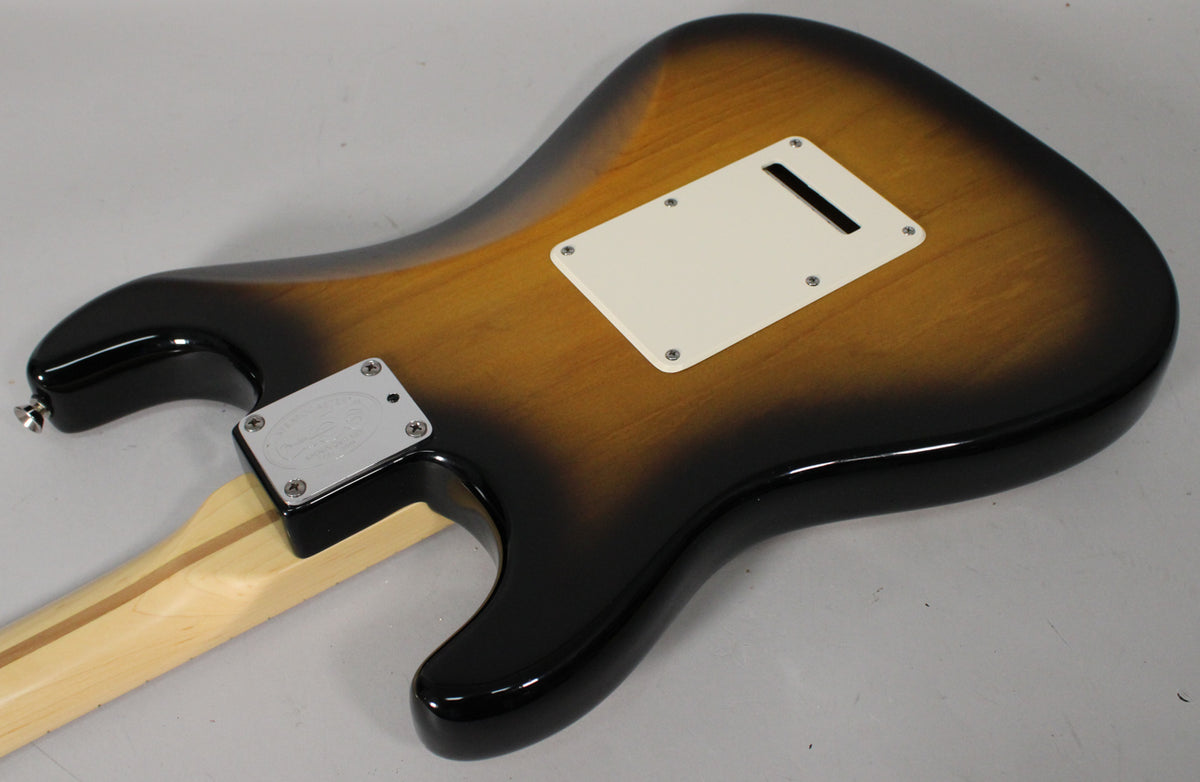 The guitar's back shows a glossy 2-color sunburst finish, a cream tremolo cover, and a chrome neck plate with four screws.