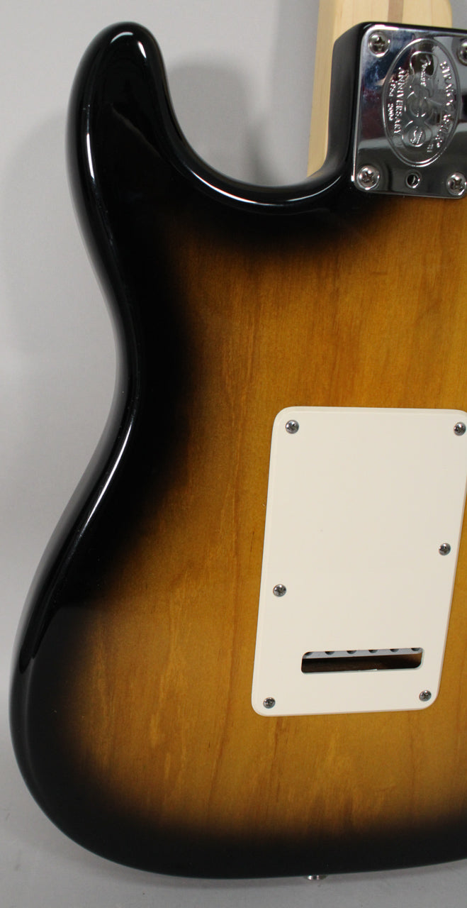 The guitar's back, showing a glossy 2-color sunburst finish, a chrome neck plate, and a rectangular white tremolo cavity cover.