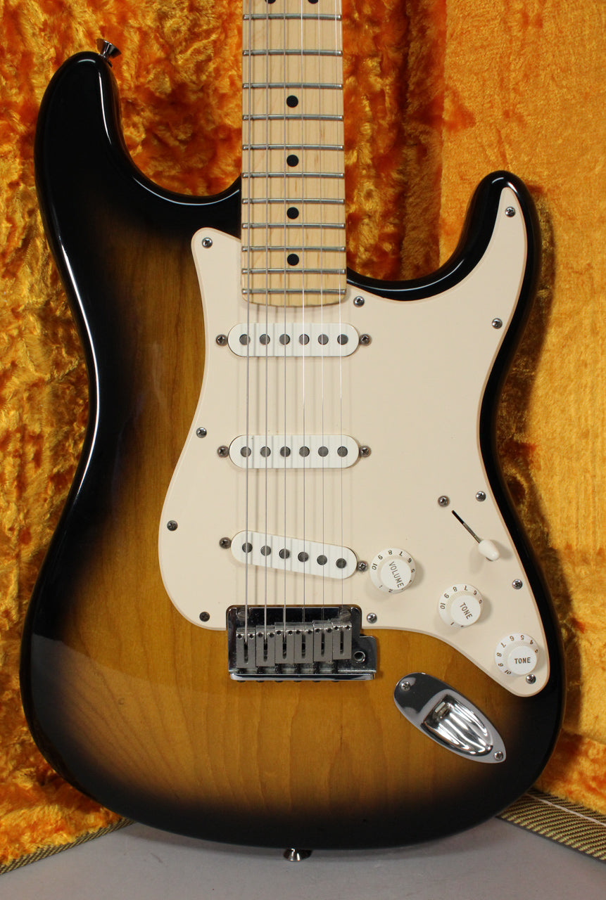 Full front view of a glossy 2-color sunburst Stratocaster with a cream pickguard, three single-coil pickups, and a maple fretboard.