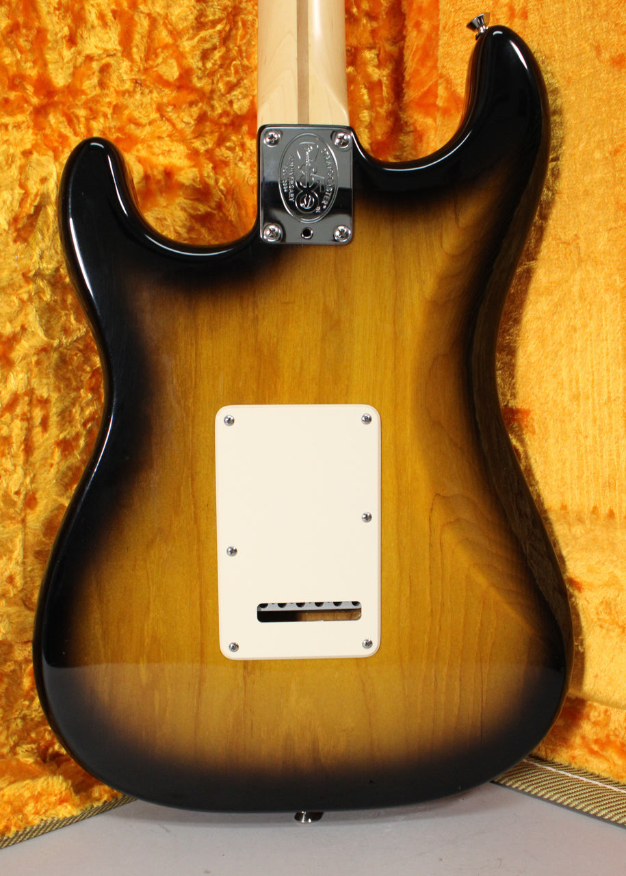 The back of a 2-Color Sunburst Stratocaster, showing the neck plate, light cream tremolo cover, and a strap button on the lower bout.