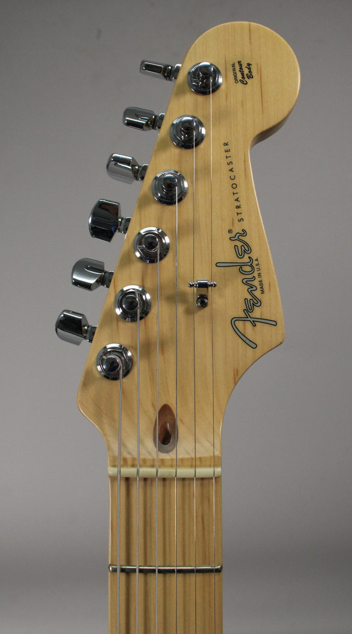 Close-up of a light maple headstock with six chrome tuners, a string tree, and a visible truss rod adjustment at the nut.