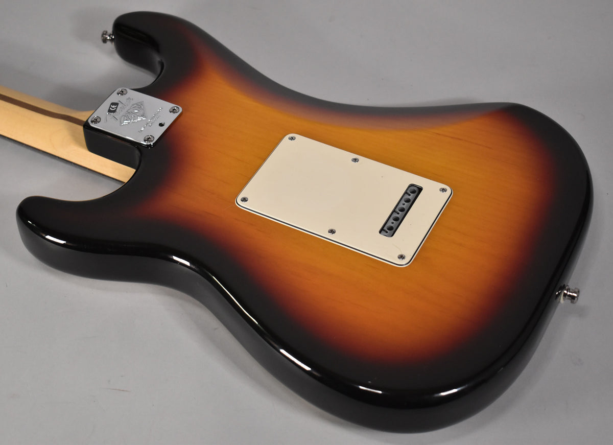 The guitar's sunburst back, showing the neck plate, tremolo cavity cover, and strap buttons, has a few minor surface scratches.