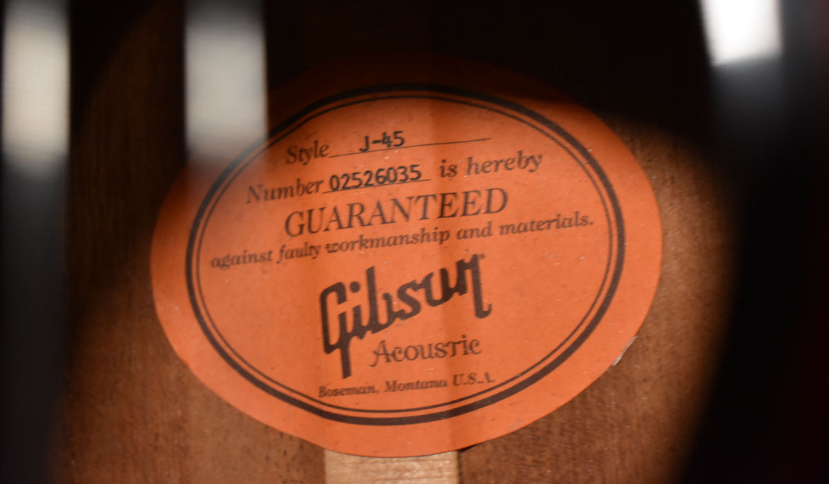 A close-up of the orange Gibson label inside the soundhole, showing the serial number and "Bozeman, Montana U.S.A."