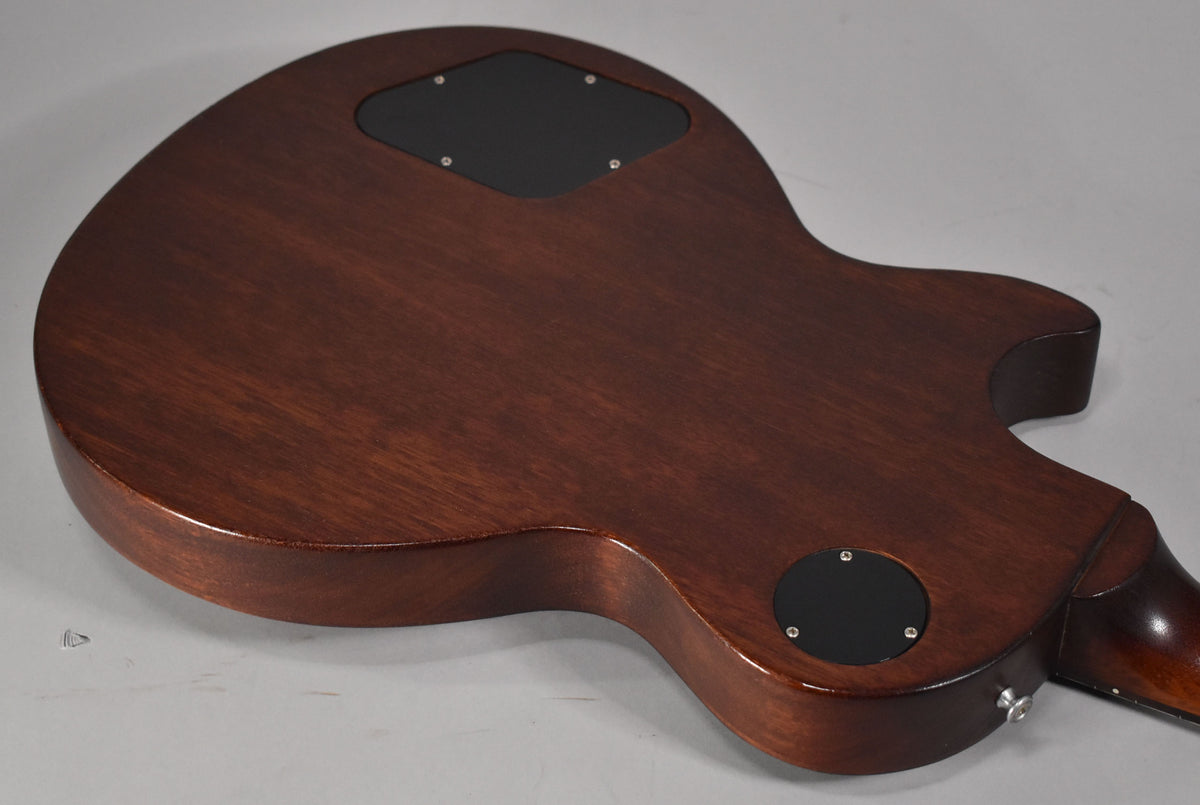 The guitar's faded walnut back, with a satin finish, shows two black control cavity covers and a chrome strap button.