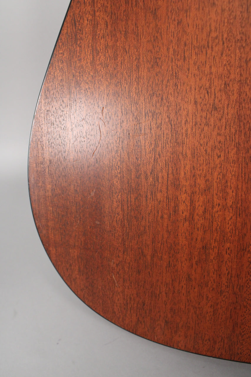 Close-up of the guitar's lower bout, showing the satin mahogany finish with visible wood grain and a few light scratches on the surface.