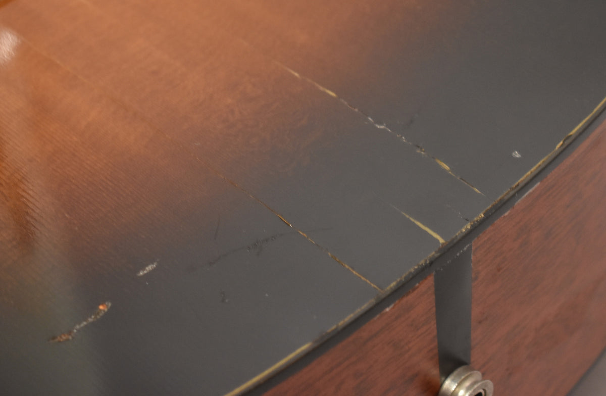 Close-up of the sunburst top with heavy finish checking, chips, and scratches, revealing lighter wood underneath.