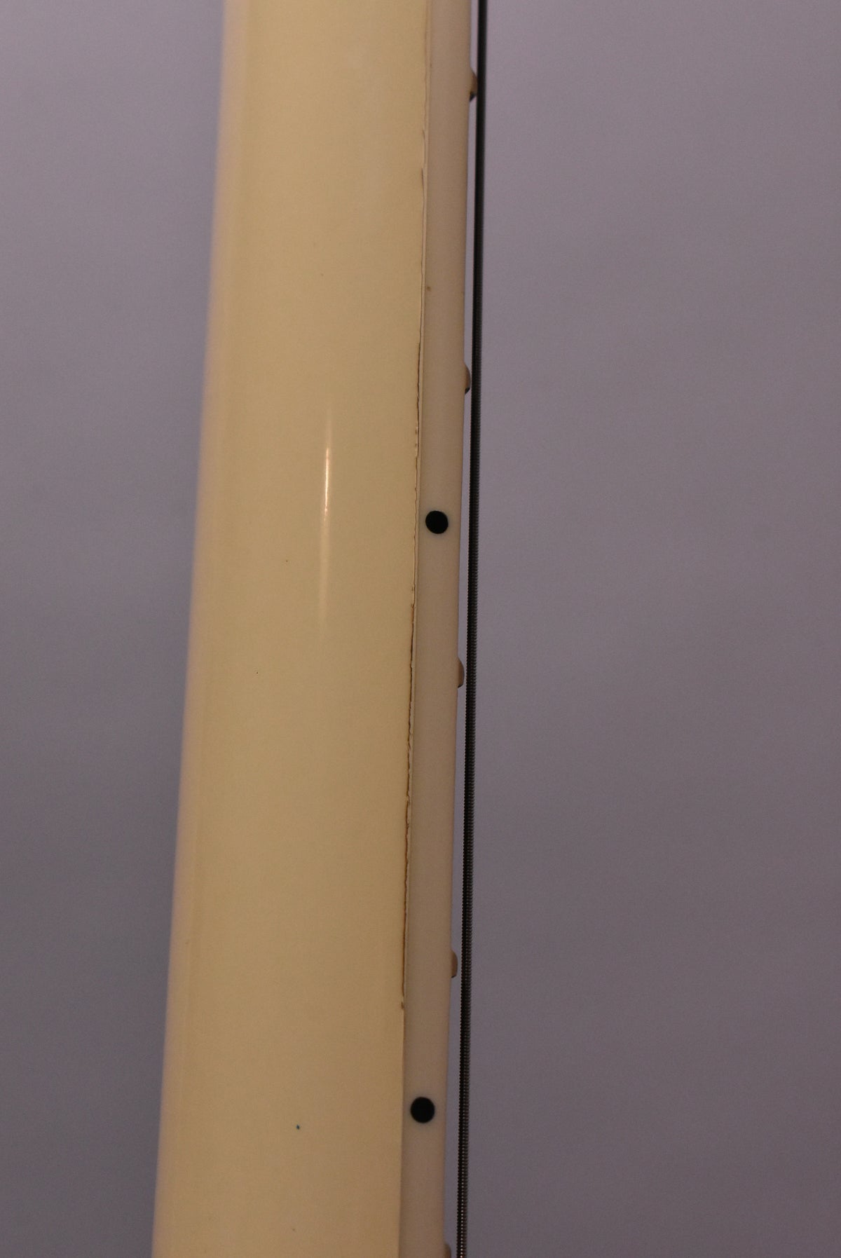 Close-up of the Alpine White neck, showing finish checking along the binding and a black side dot marker.