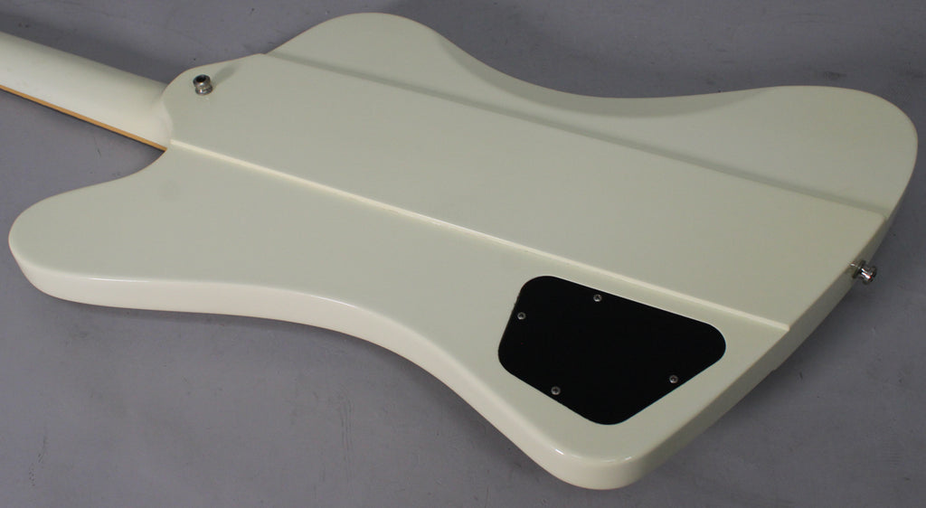 The back of an Alpine White Firebird V, showing the neck joint, control cavity cover, and strap button.
