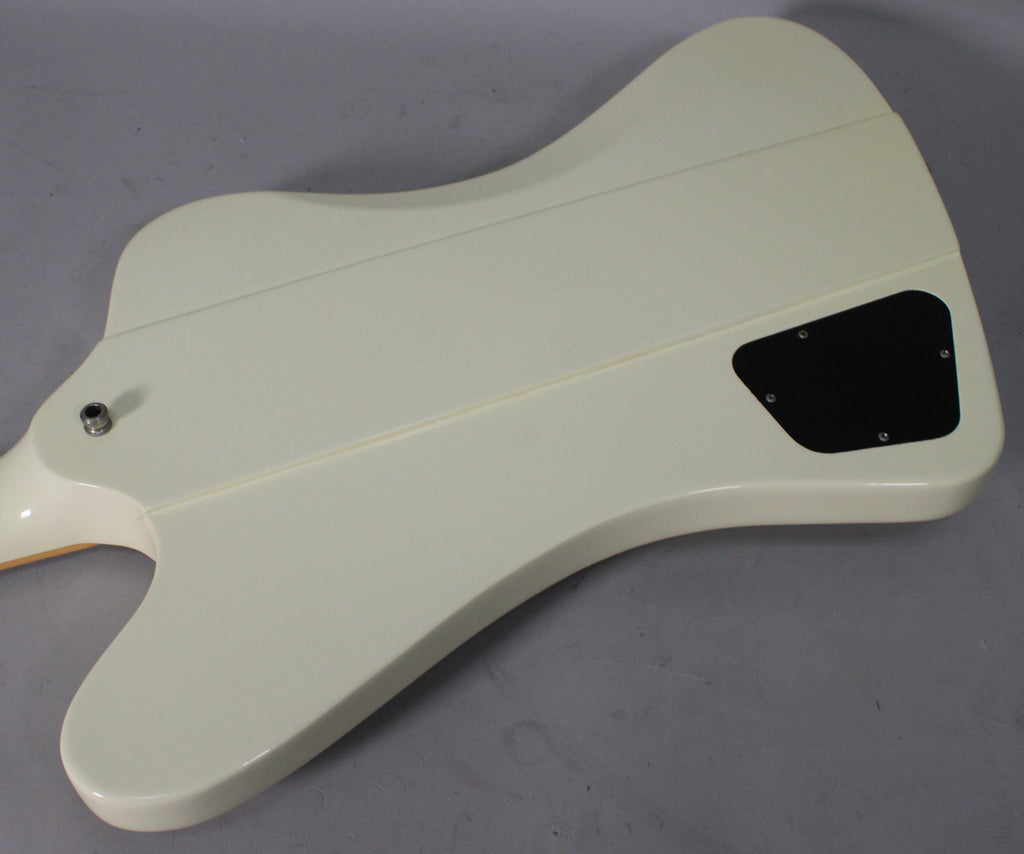 The back of an Alpine White Firebird V, showing the control cavity cover and output jack, with minor surface wear.