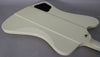 The back of an Alpine White Firebird V, showing the neck joint, output jack, and black control cavity cover.