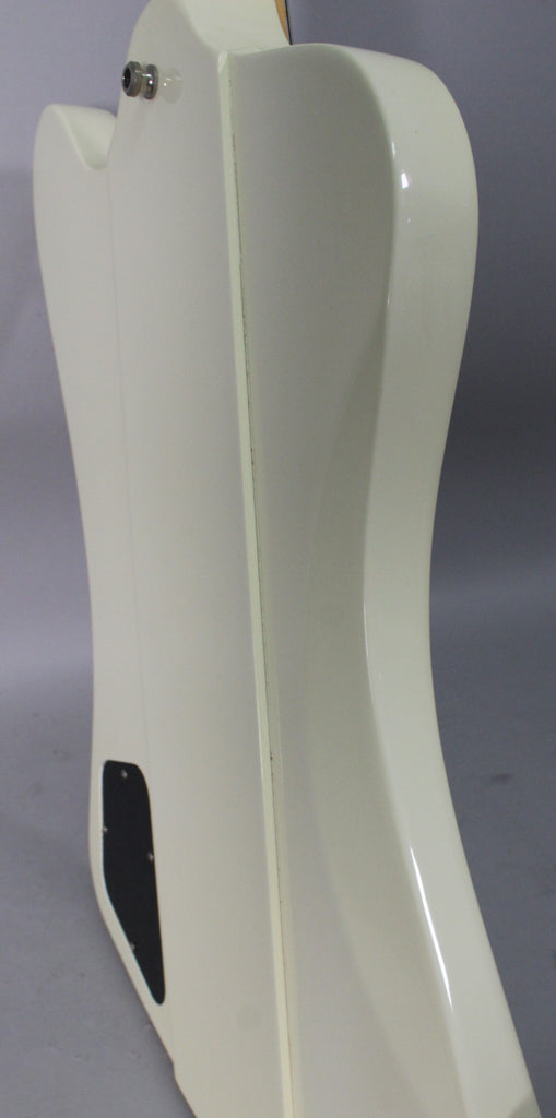 Close-up of the guitar's side, showing the output jack, a black control plate, and minor finish wear along the body seam.
