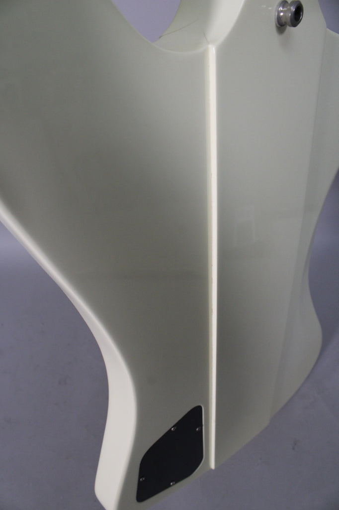 Close-up of the guitar's lower body, showing the glossy Alpine White finish, output jack, and black control cavity cover.