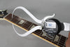 A digital fret height gauge measures the guitar's fretboard, showing a reading of 0.82, with trapezoid inlays visible.