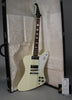 Full-length view of an off-white Firebird V with a white pickguard, chrome hardware, and four black control knobs, leaning in its open case.