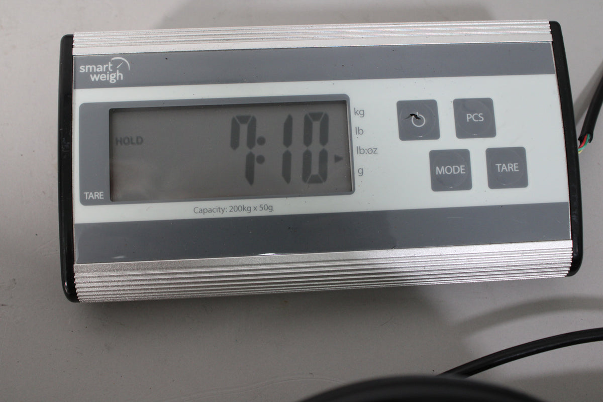 A digital scale displays "7.10" in pounds, indicating the guitar's weight, with control buttons visible.