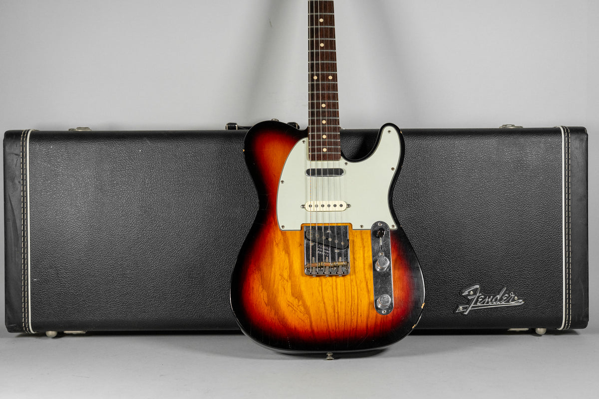 Full-front view of a sunburst Telecaster with a white pickguard, showing heavy wear on the body and control plate.