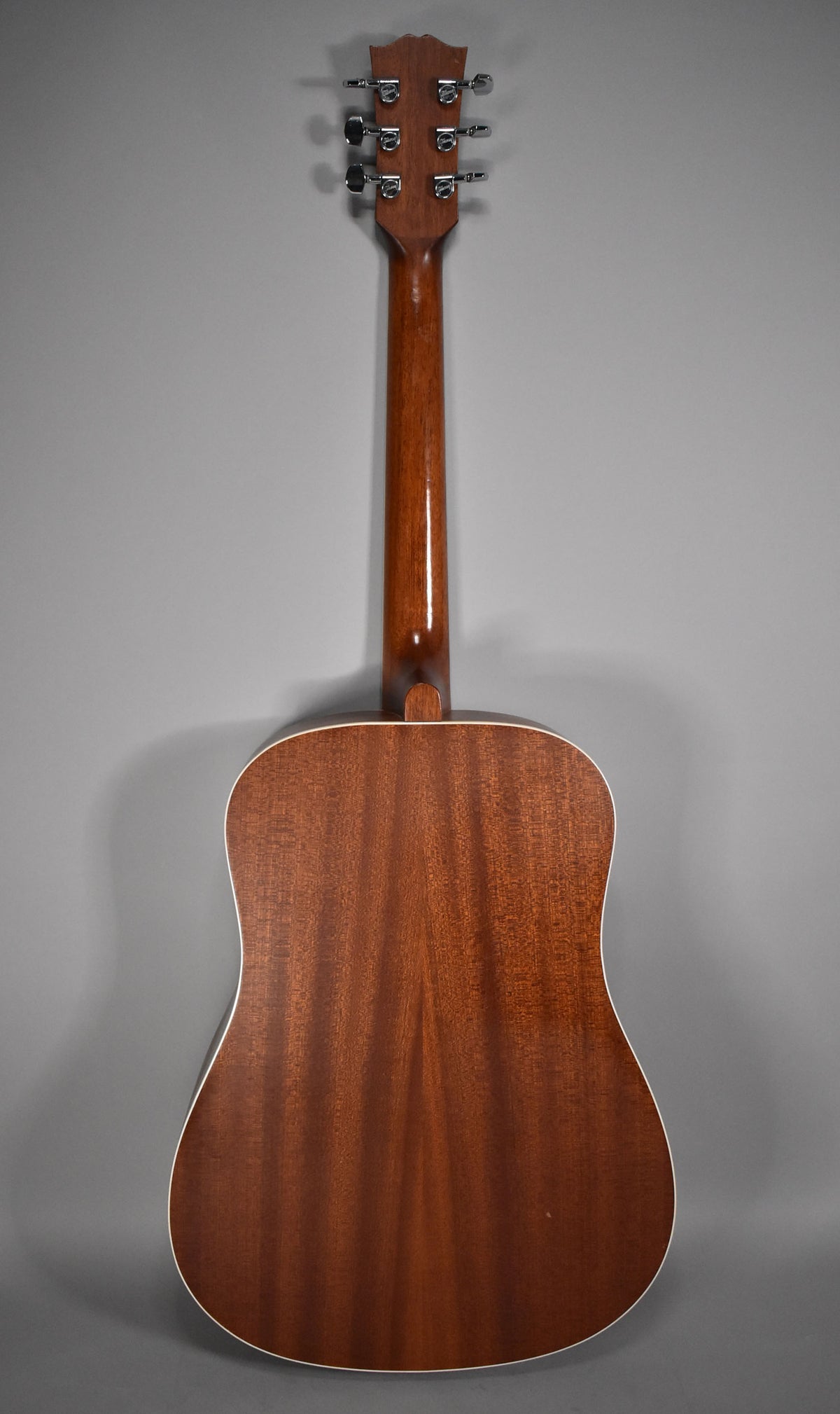 The guitar's back and neck are shown, featuring a natural satin finish with visible wood grain and chrome tuners.