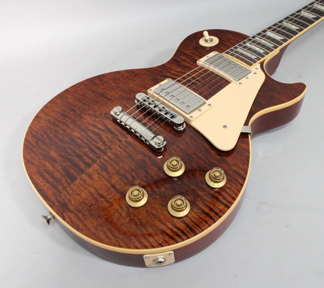 The rootbeer burst Les Paul body, with a flamed maple top, shows cream binding, pickguard, and pickup rings.