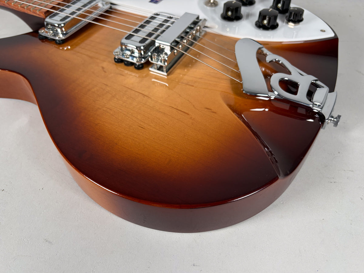 Close-up of the guitar's lower body, showing the Montezuma Brown sunburst finish, chrome R-tailpiece, and two chrome toaster-top pickups.