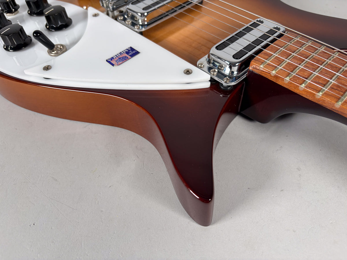 Close-up of the guitar's lower body, showing the Montezuma Brown finish, white pickguard, control knobs, and neck pickup.