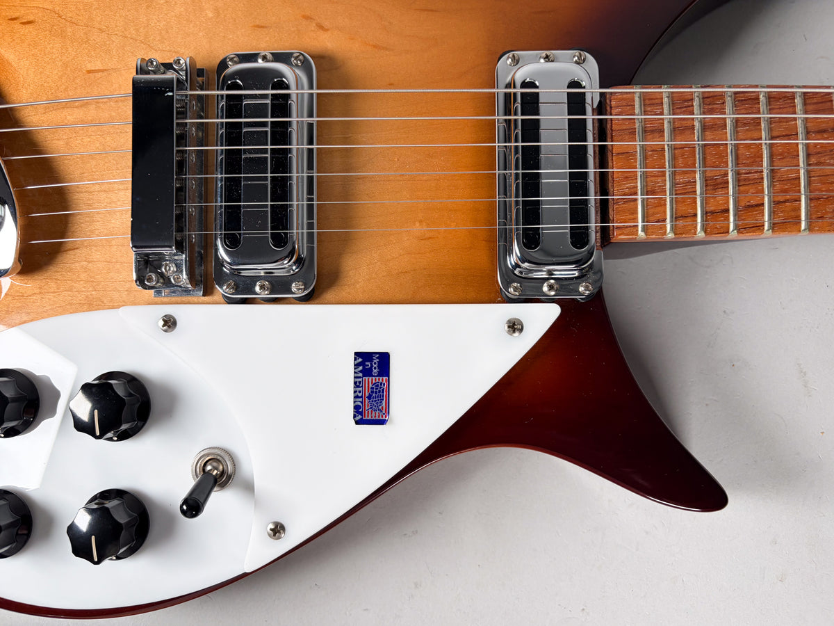 Close-up of the Montezuma Brown body, showing the white pickguard, two chrome pickups, four black control knobs, and a toggle switch.