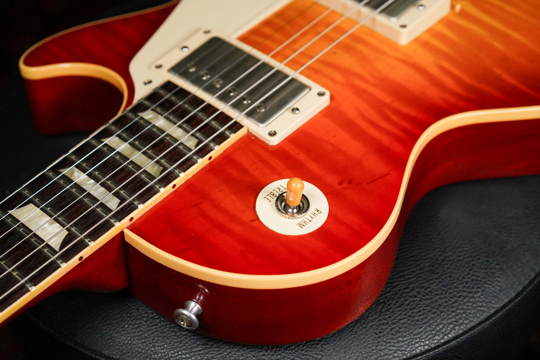 Close-up of the sunburst body, showing the lower bout, neck, and bridge pickup, with a cream toggle switch plate.