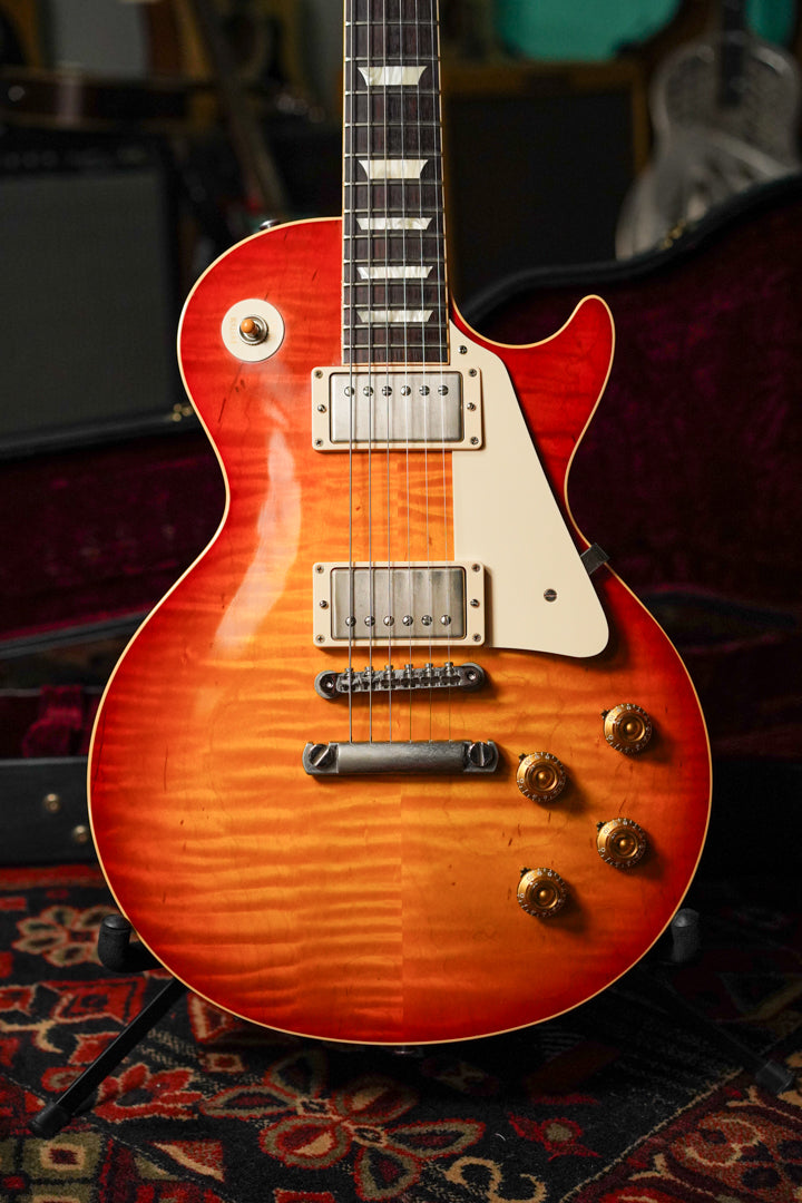 Full front view of a sunburst electric guitar with a flamed maple top, cream binding, and aged nickel hardware.