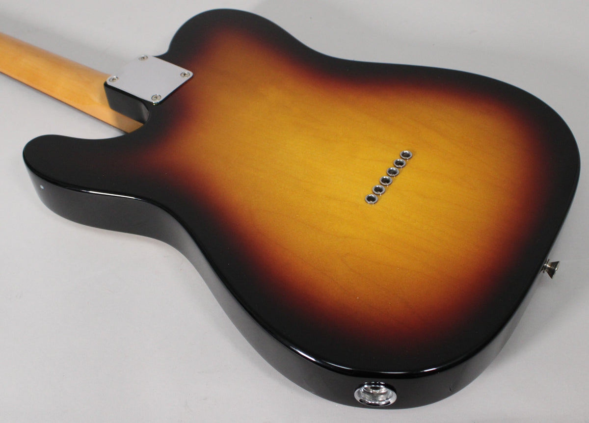 The back of a sunburst Telecaster body, showing the neck plate, string ferrules, and output jack.