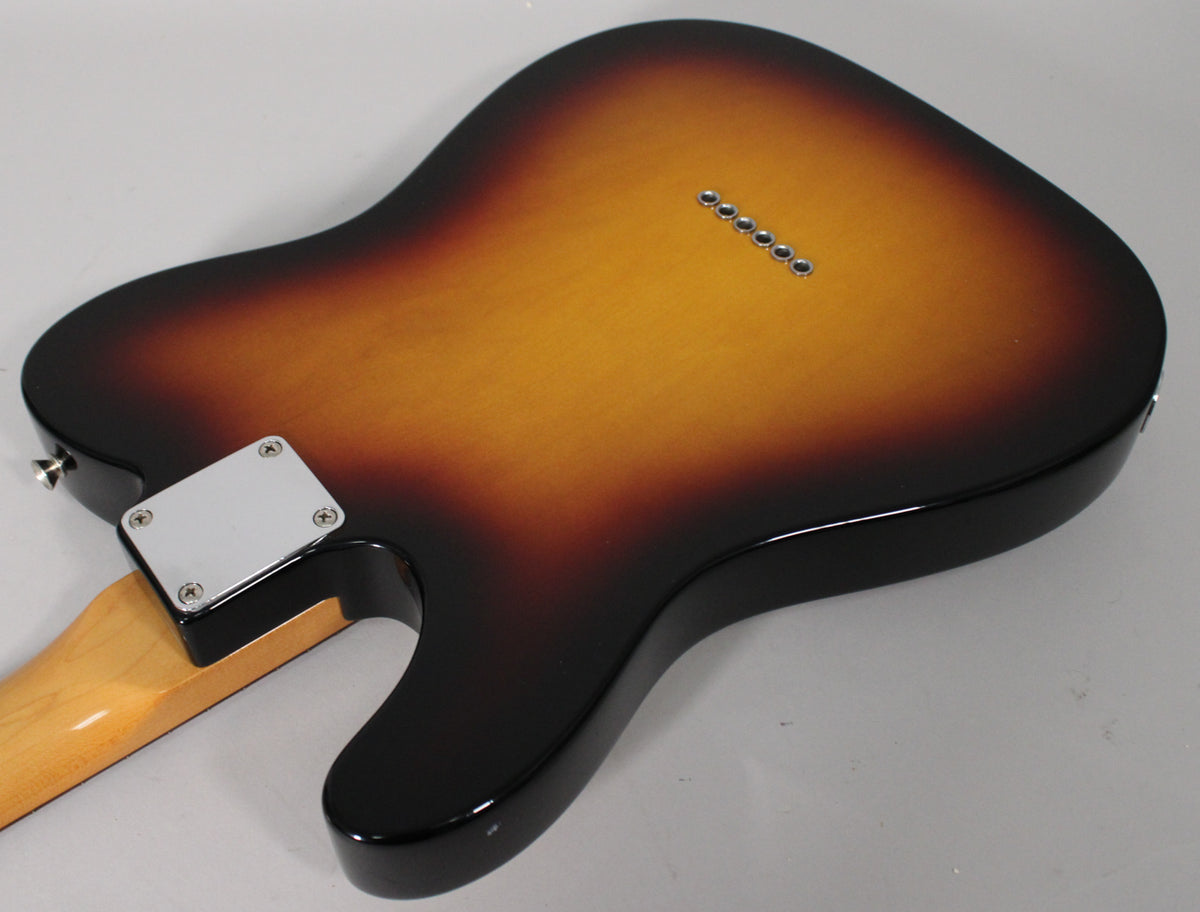 The guitar's sunburst body, viewed from the back, shows a chrome neck plate and six string-through-body ferrules.