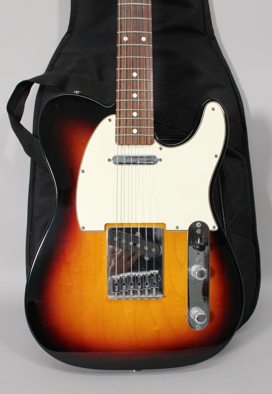 Full-frame view of a sunburst guitar with a white pickguard, chrome hardware, and a humbucker bridge pickup.