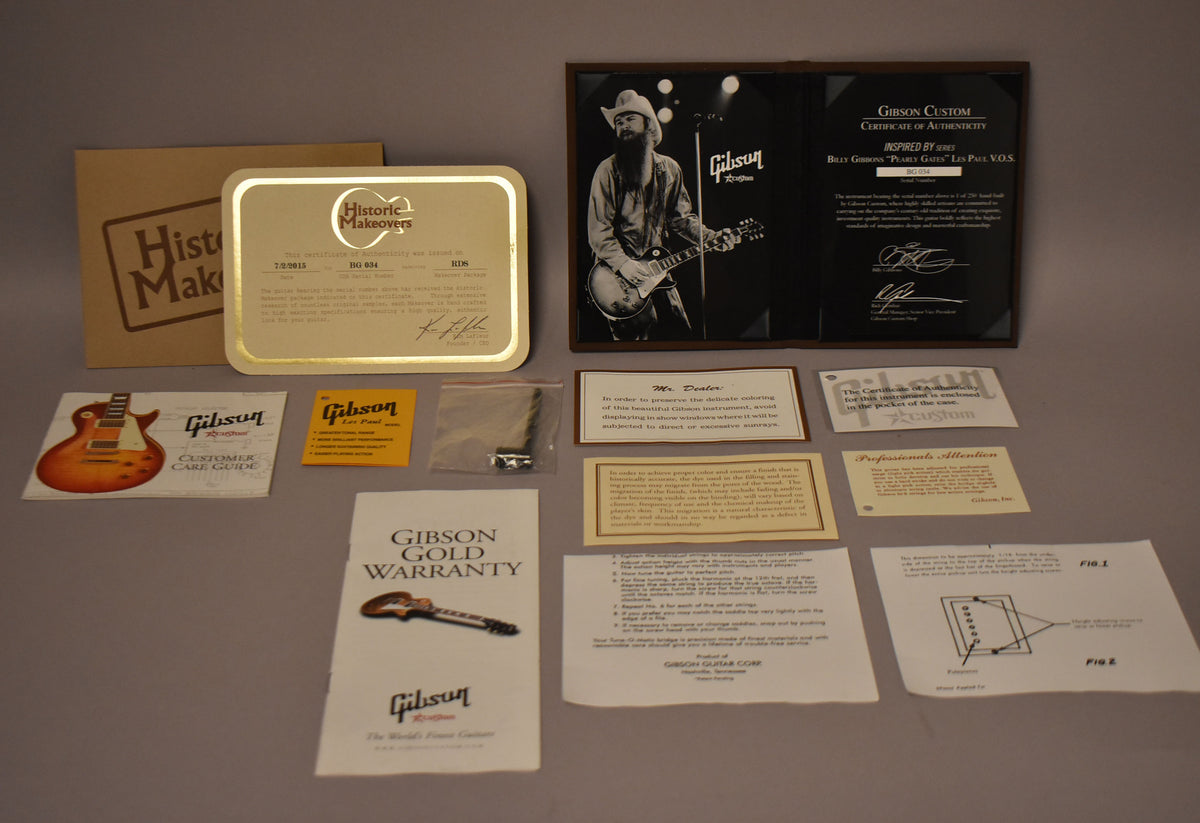Overhead shot of various documents, including a framed photo of Billy Gibbons, warranty cards, and care guides.
