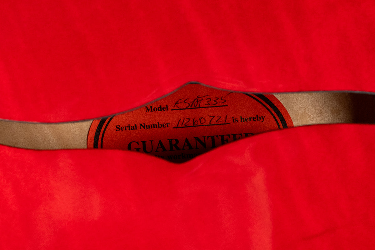 Close-up of the guitar's orange label inside the f-hole, showing "Model ES-335" and "Serial Number 11260721".