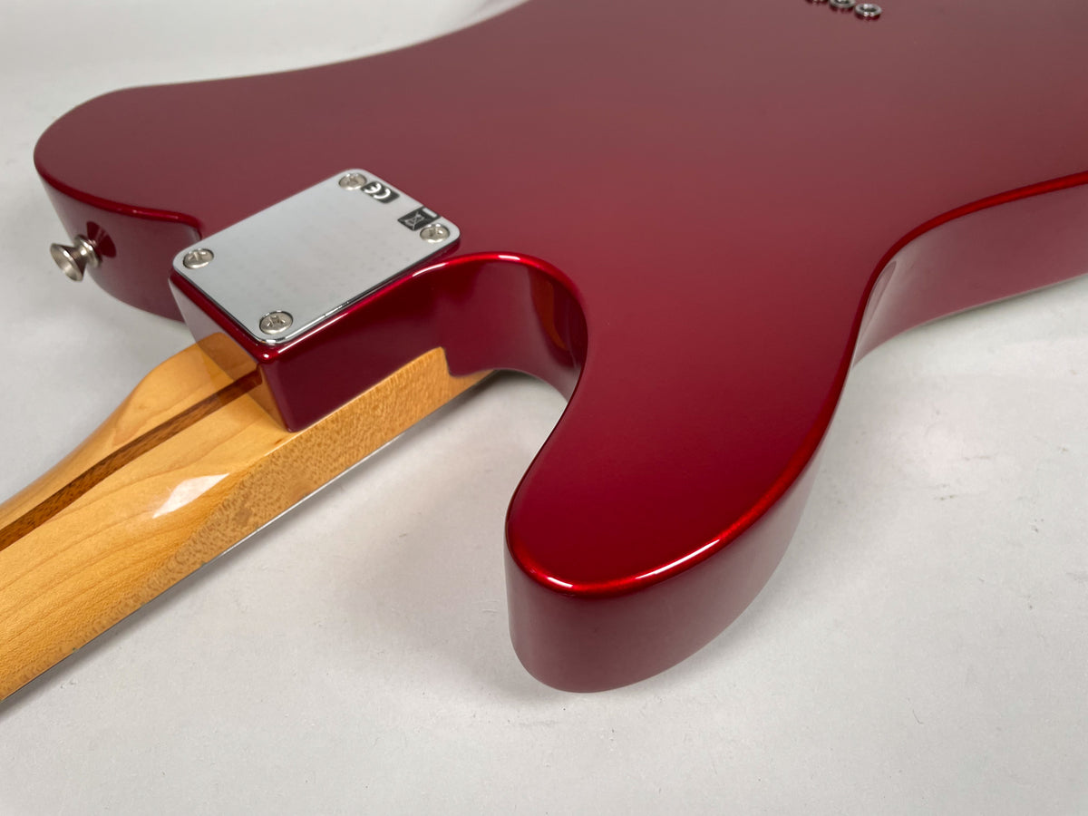 Rear view of the Candy Apple Red body, showing the chrome neck plate, light maple neck, and a few minor scuffs.