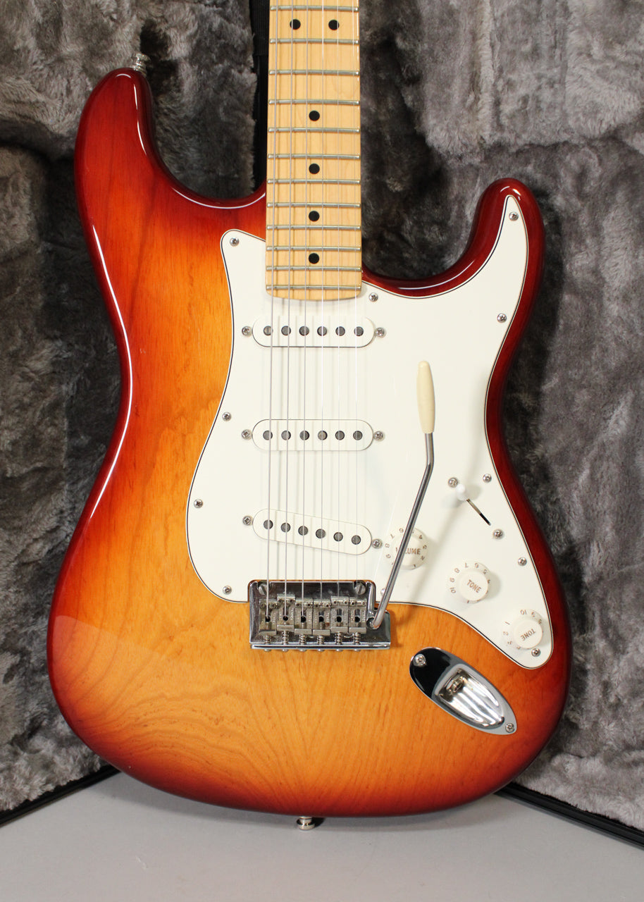 Full-front view of a Sienna Burst Stratocaster with a maple neck, white pickguard, three single-coil pickups, and a tremolo arm.
