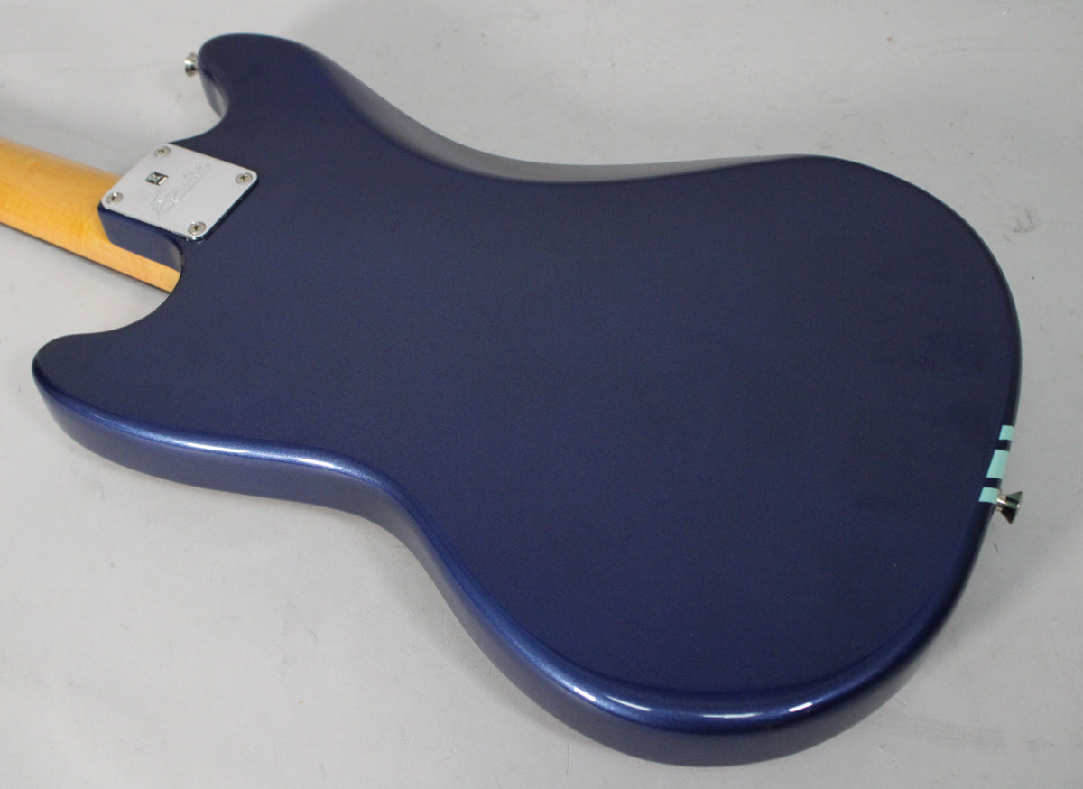 The back of a Lake Placid Blue Mustang body, showing the neck plate, a light racing stripe, and a few minor scuffs.