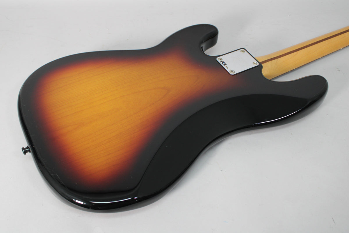 The back of a sunburst bass body, showing the neck plate and the lower horn, with minor surface scratches.
