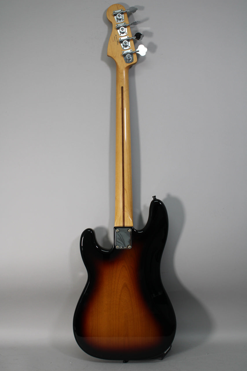 Full rear view of a sunburst bass with a glossy finish, showing the maple neck, chrome tuners, and neck plate.