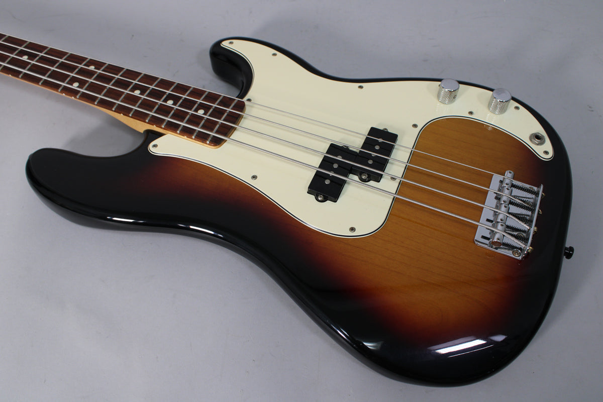 Sunburst bass, angled from the neck to the lower bout, with a cream pickguard, split pickup, chrome bridge, and two control knobs.