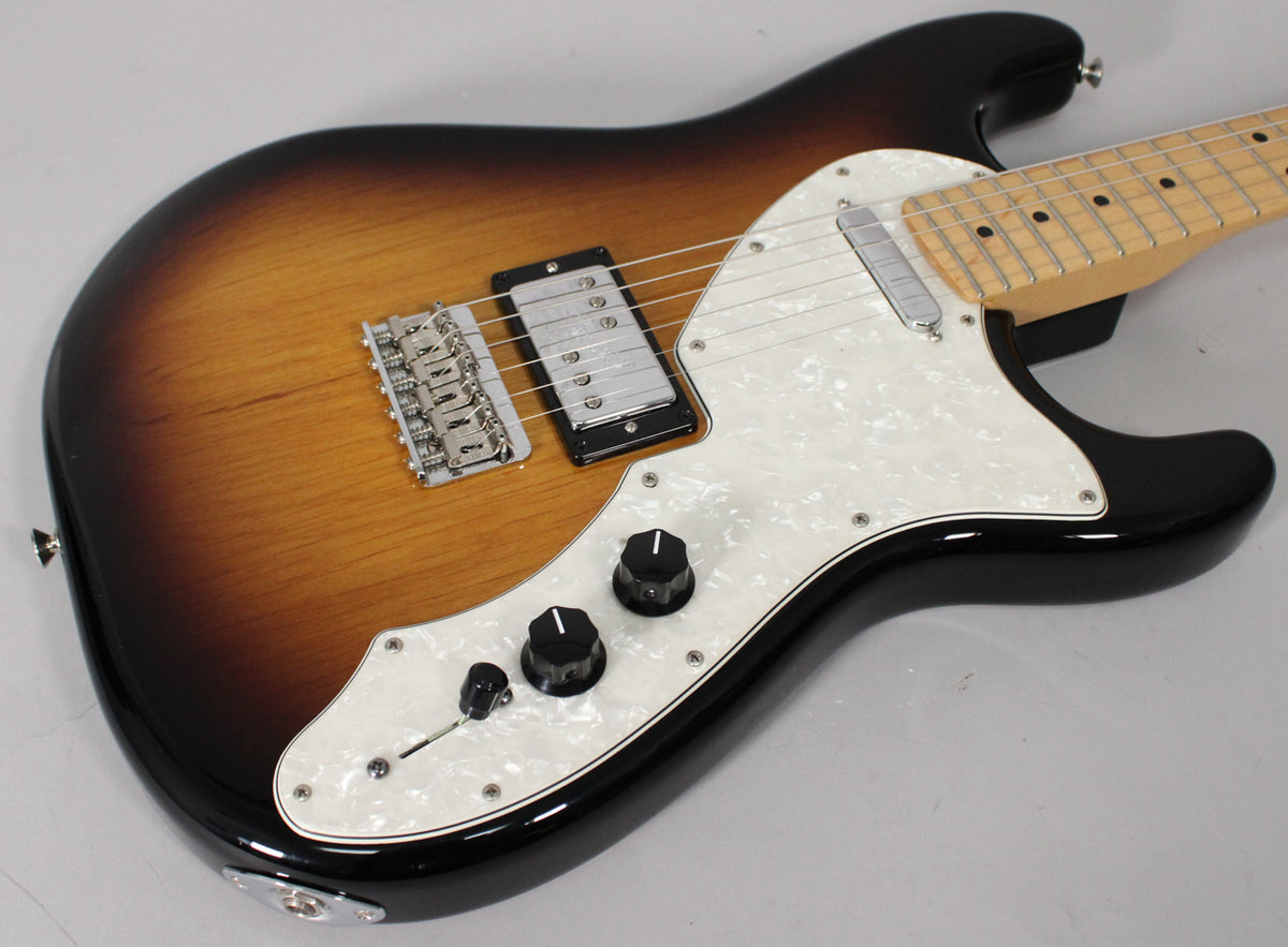 Sunburst electric guitar, angled top-down, showing a pearloid pickguard, two black control knobs, and a humbucker and single-coil pickup.