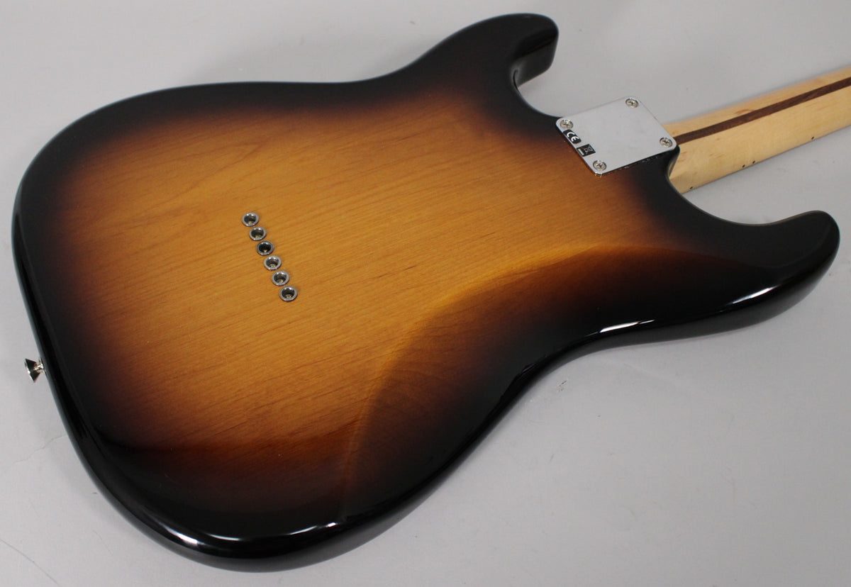 The guitar's glossy 2-color sunburst back, with six string-through-body ferrules, shows light reflections and no visible wear.
